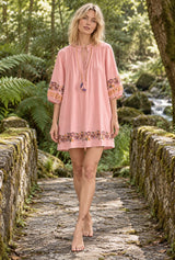 Wild Rose Boho AI editorial full-body hero, Boho Mini Dress – “Blush Botanica” Pink Floral Embroidered Tassel-Tie Dress, pink colorway