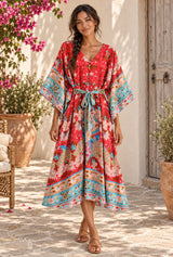 Wild Flower Kelly Red kaftan, red with turquoise floral borders — styled on an AI-generated model