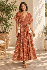 Bohemian Maxi Gown – “Amber Garden” Brown Floral Batwing Sleeve Tassel Dress — styled on an AI-generated model
