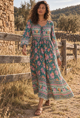 Emerald Wildflower green floral maxi dress, walking editorial view with AI-generated adult model