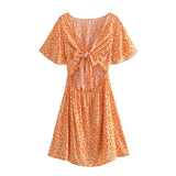 Boho Mini Dress – “Wildflower Waltz” Floral & Leopard Bow-Front Cutout Dress