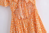 Boho Mini Dress – “Wildflower Waltz” Floral & Leopard Bow-Front Cutout Dress